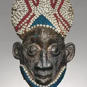 A carved wooden helmet mask from the Grassfields region of Cameroon